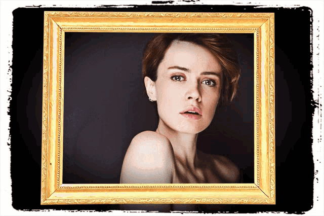 a picture of a woman is in a gold frame