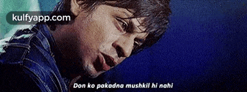 a close up of a man 's face with the words `` don ko pakadna muskil hi nahi '' written on it .