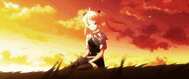 a girl with red hair is sitting in the grass