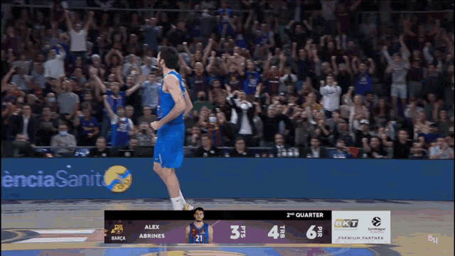 a basketball game is being played in front of a crowd with a banner that says encia sanita