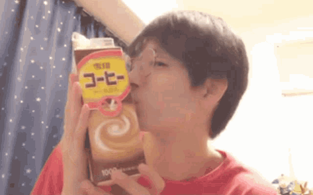 a man is drinking from a carton of coffee that says 1000 on it
