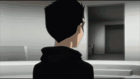 a man in a black hoodie looks out a doorway