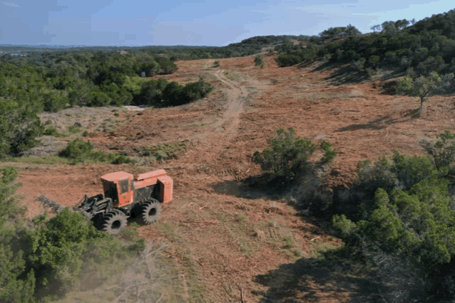 an aerial view of a tractor in a field