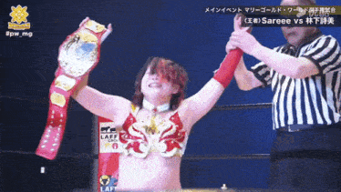 a woman in a wrestling ring holds up a belt that says laff on it