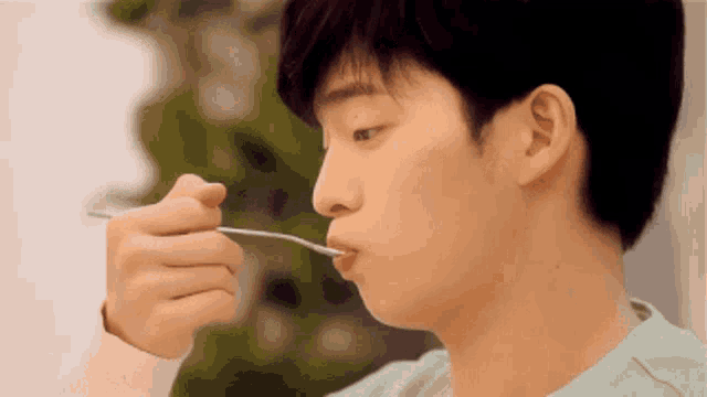 a close up of a person eating with a spoon
