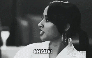 a black and white photo of a woman with the words `` shade '' written on her face .
