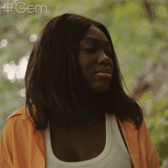 a close up of a woman 's face with the word gem in the corner