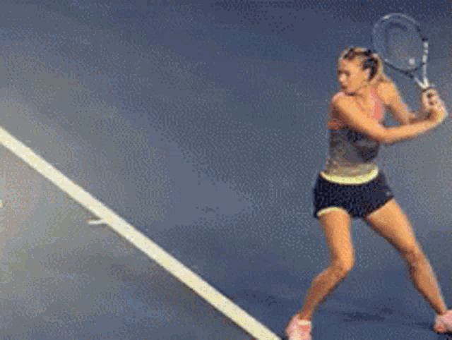 a woman is swinging a tennis racquet on a tennis court with a sign that says florida