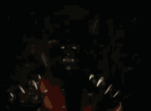 a black panther with sharp claws and yellow eyes is coming out of the dark with its mouth open .