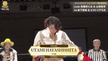 a woman stands in front of a sign that says utami hayashishita