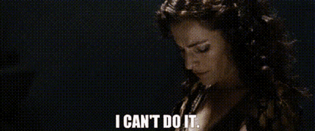 a woman with curly hair is holding a microphone and saying `` i can 't do it . ''