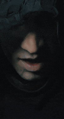 a close up of a man 's face in the dark with his mouth open