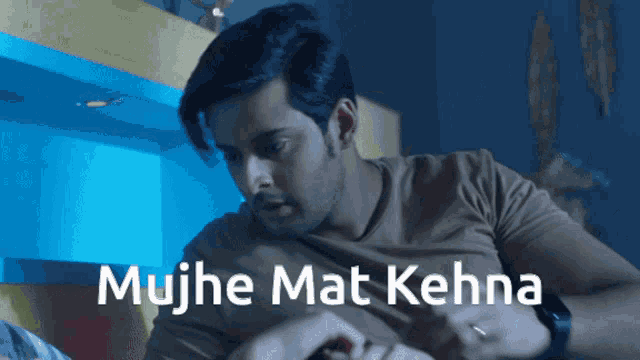 a man in a brown shirt with the words mujhe mat kehna written below him