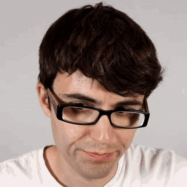 a man wearing glasses and a white shirt