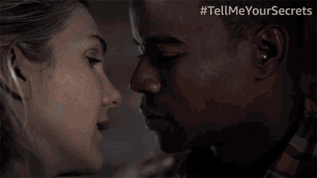 a man and a woman kissing with the hashtag tell me your secrets on the bottom right
