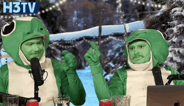 two men in frog costumes are sitting in front of a microphone and a laptop with h3tv written on the bottom