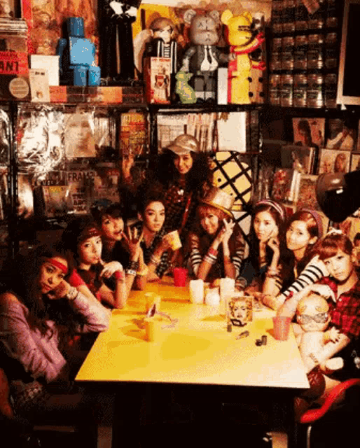 a group of girls sitting around a table with a sign that says ant