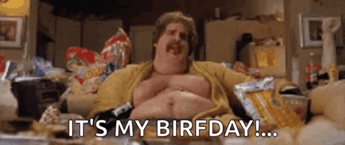a fat man is sitting on a couch eating chips .