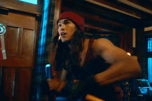 a man in a red hat is holding a magic wand and says magic wand blah blah blah