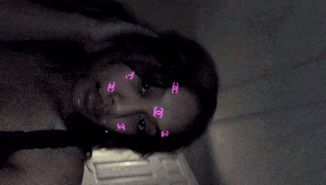 a girl with pink chanel stickers on her face .