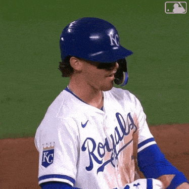 a baseball player for the royals is wearing a blue helmet and sunglasses