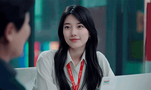 a woman wearing a lanyard that says samsung