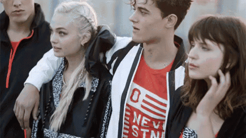 a group of young people are posing for a picture and one of them is wearing a shirt that says " new york "