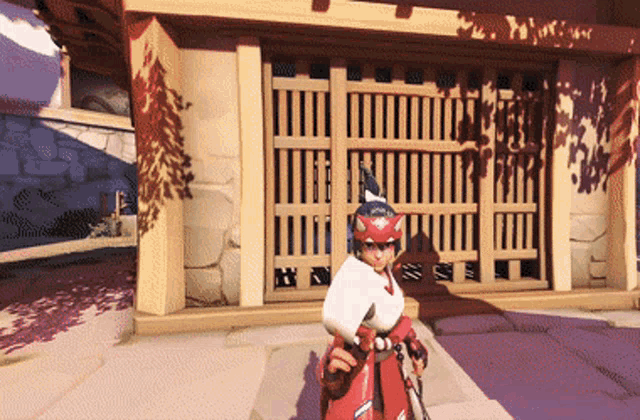 a person in a red and white outfit is standing in front of a gate
