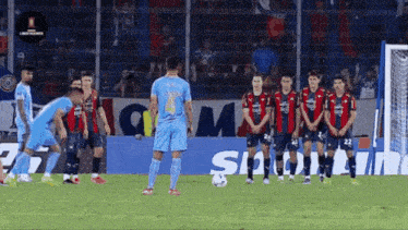 a group of soccer players standing in front of a sign that says ' sigma ' on it