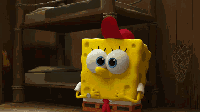 a cartoon character named spongebob has a red rooster hat on
