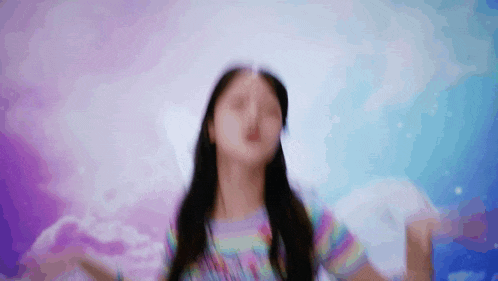 a blurry picture of a young girl with her arms outstretched .