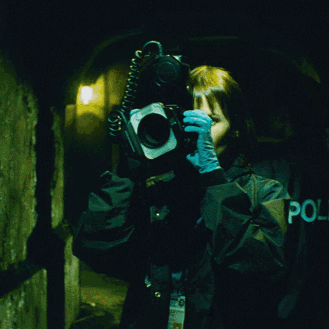 a police officer is holding a flashlight in his hand