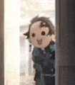 a close up of a cartoon character peeking out of a door .