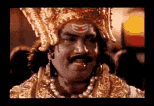 a man with a mustache and a crown on his head looks at the camera