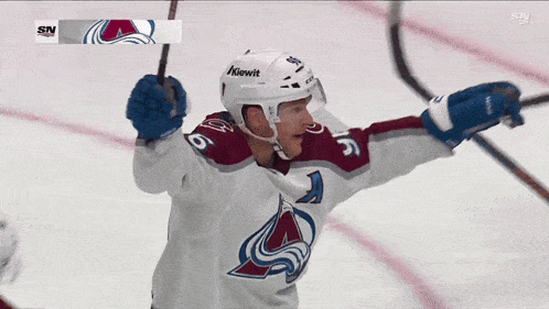 a hockey player with the number 5 on his jersey is celebrating