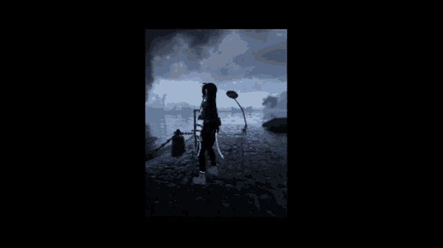 a silhouette of a person standing on a rocky road