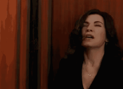 a woman is standing in an elevator with her mouth open .