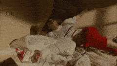 a person laying on a bed with a bag of lays chips