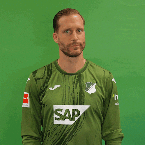 a man wearing a green shirt with the word sap on the front