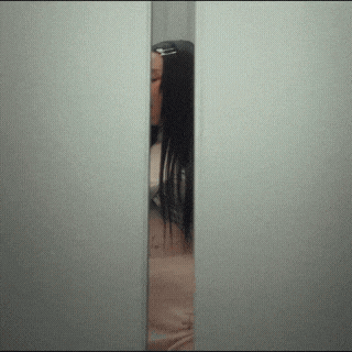 a woman 's back is shown through a doorway