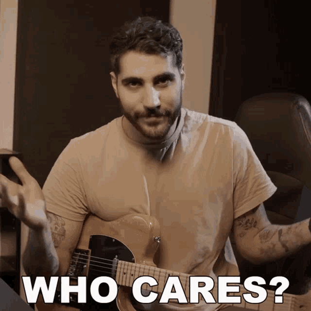 a man holding a guitar with the words who cares below him