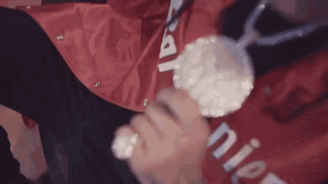 a person wearing a red shirt that says supreme on it