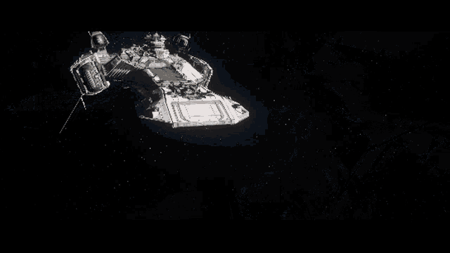 a black and white photo of a space ship in the dark