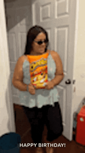 a woman wearing sunglasses is holding a bag of cheetos and says happy birthday .