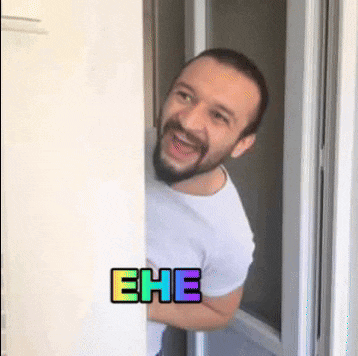 a man with a beard is peeking out from behind a door and the word ehe is on the wall behind him