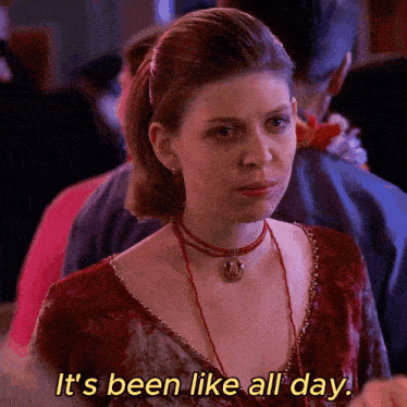 a woman says it 's been like all day while wearing a red dress