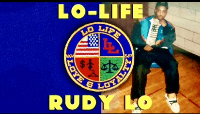 a man is sitting in front of a logo that says lo-life and rudy lo