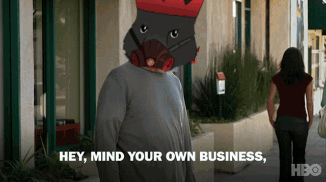 a man wearing a gas mask says hey mind your own business while a woman walks behind him