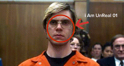 a man wearing glasses and an orange jacket has a red circle around his face and the words " i am unreal 01 " below him