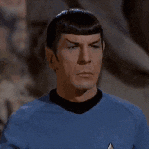 the man is wearing a blue shirt and waving his hand .